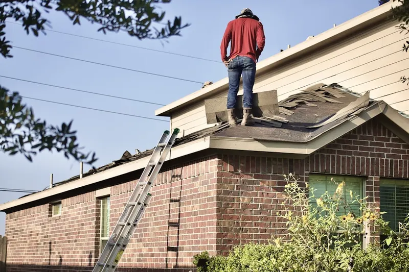 Professional roofer working on a residential roof in Harrisonburg